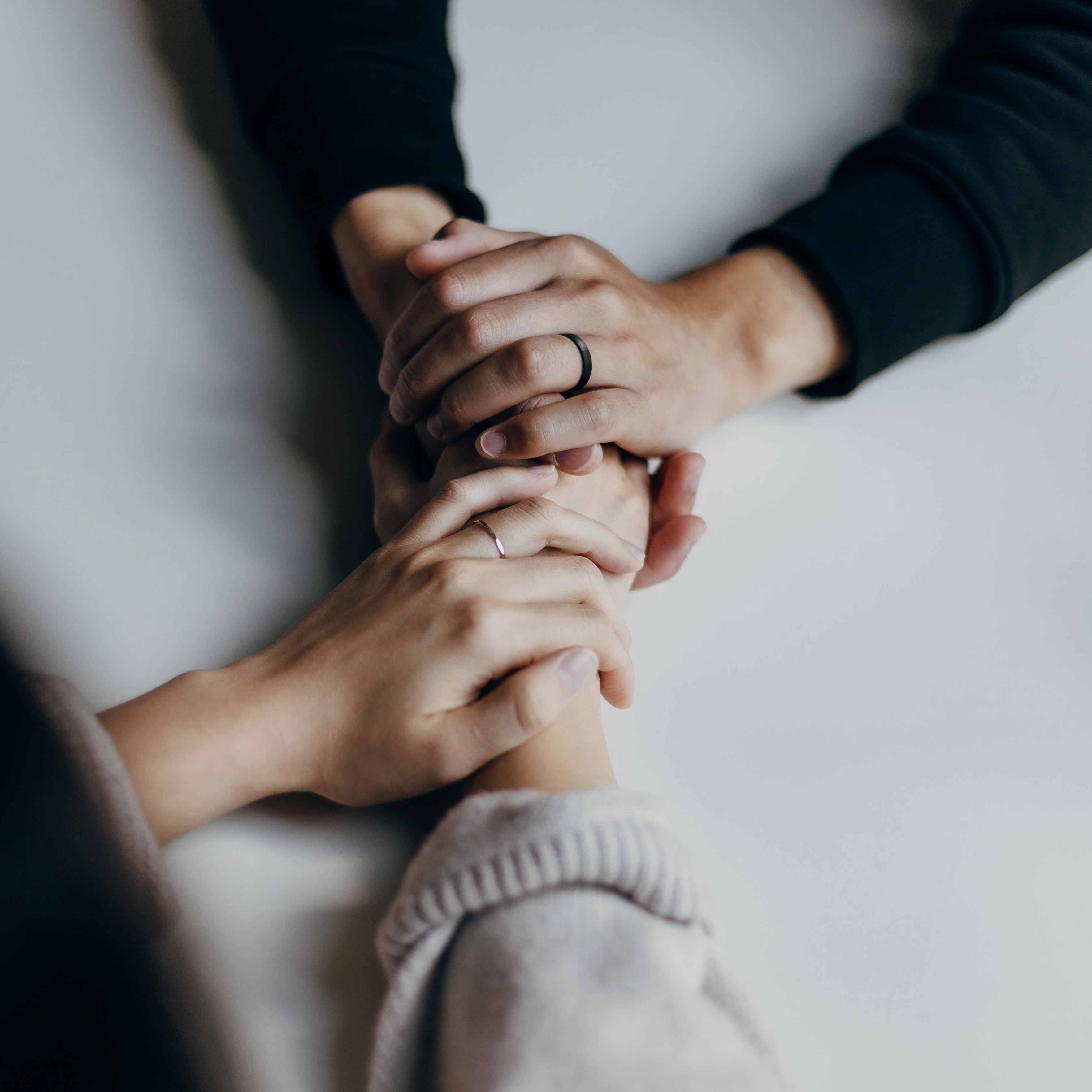 Two hands holding each other.