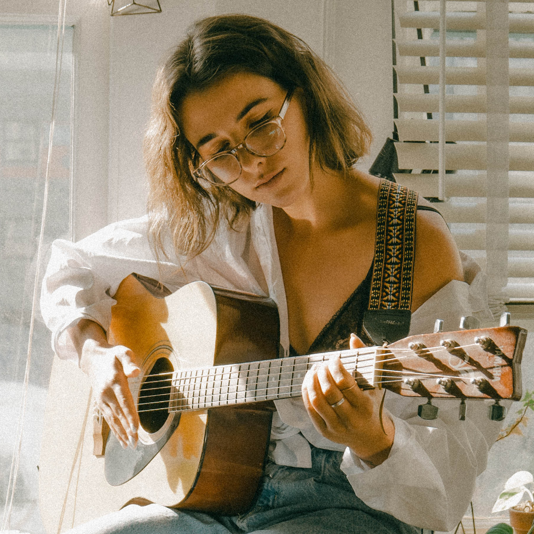 Woman playing guitar.