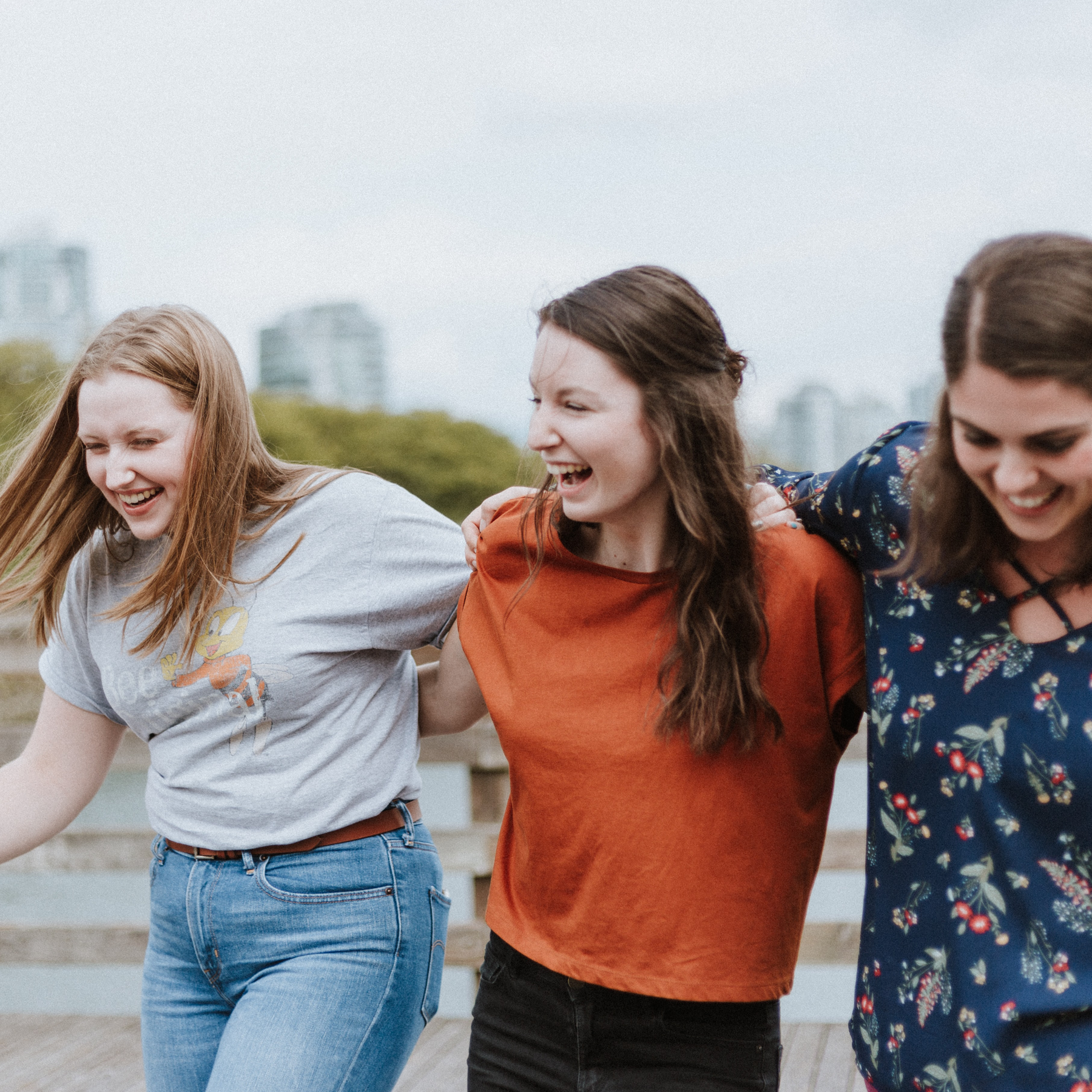 Three women laughing.